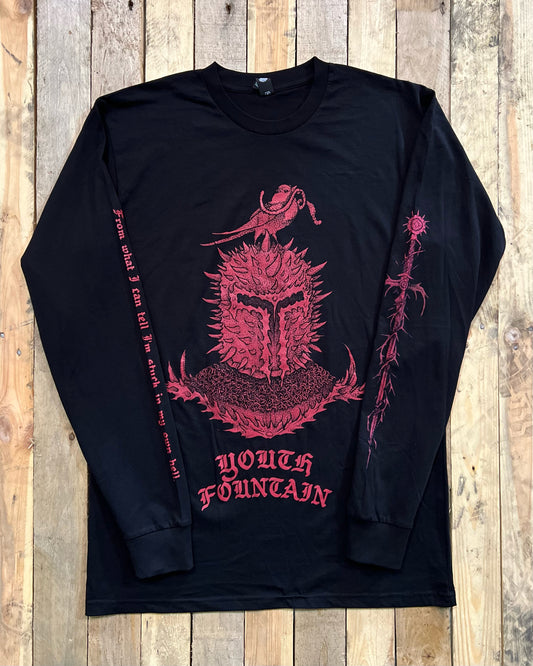 Black long-sleeve shirt with red screen printed design on a wooden surface