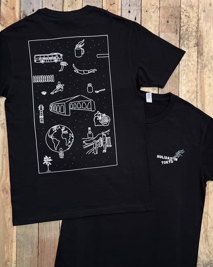 Black t-shirt with large illustrated white graphic design on the back and small front pocket print on a wooden surface